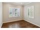 Well-lit bedroom with hardwood floors and plantation shutters at 4891 Maymont Park Cir, Bradenton, FL 34203