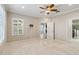 Spacious bedroom with access to bathroom and another room. Neutral colors and ceiling fan at 4891 Maymont Park Cir, Bradenton, FL 34203