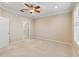 Bright bedroom with ceiling fan, door to bathroom, and window with shutters at 4891 Maymont Park Cir, Bradenton, FL 34203