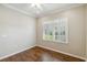 Bedroom with hardwood floors, plantation shutters and ceiling fan at 4891 Maymont Park Cir, Bradenton, FL 34203