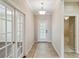 Bright entryway with tile flooring, neutral walls, and double doors at 4891 Maymont Park Cir, Bradenton, FL 34203