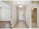 Bright entryway with tile flooring, neutral walls, and double doors at 4891 Maymont Park Cir, Bradenton, FL 34203