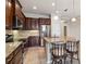 Kitchen features granite countertops, stainless steel appliances, and dark wood cabinetry at 4891 Maymont Park Cir, Bradenton, FL 34203