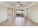 Living room with high ceilings, sliding doors to patio, and ceiling fan at 4891 Maymont Park Cir, Bradenton, FL 34203