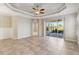 Living room features high ceilings, sliding doors and ceiling fan at 4891 Maymont Park Cir, Bradenton, FL 34203