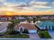 Stunning aerial view of a home near a lake at sunset at 5061 Seagrass Dr, Venice, FL 34293