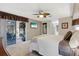 Main bedroom with backyard access, featuring a king-size bed and ceiling fan at 5061 Seagrass Dr, Venice, FL 34293