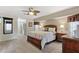 Bedroom with wooden furniture, ceiling fan and carpeted floor at 5061 Seagrass Dr, Venice, FL 34293