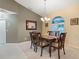 Spacious dining area with a large table, chandelier, and access to other rooms at 5061 Seagrass Dr, Venice, FL 34293