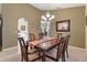 Bright dining room features a wood table with six chairs, chandelier, and artwork at 5061 Seagrass Dr, Venice, FL 34293