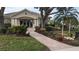 Landscaped exterior view of building with inviting walkway and lush tropical foliage creating a serene atmosphere at 5061 Seagrass Dr, Venice, FL 34293