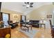 Spacious living room featuring hardwood floors, comfortable leather furniture, and a ceiling fan at 5061 Seagrass Dr, Venice, FL 34293