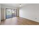 Bedroom with wood-look flooring and sliding glass doors to patio at 5269 Myrtle Wood Rd # 35, Sarasota, FL 34235