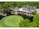 Aerial view of a clubhouse near a golf course and pond at 5269 Myrtle Wood Rd # 35, Sarasota, FL 34235