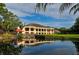 Picturesque clubhouse reflected in a calm pond at 5269 Myrtle Wood Rd # 35, Sarasota, FL 34235