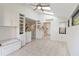 White kitchen cabinets, tile floor and view into the sunroom at 5269 Myrtle Wood Rd # 35, Sarasota, FL 34235