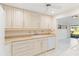 White cabinets and countertops, view of sunroom and kitchen appliances at 5269 Myrtle Wood Rd # 35, Sarasota, FL 34235