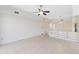 Living room with tile floor, ceiling fan and built-in shelving at 5269 Myrtle Wood Rd # 35, Sarasota, FL 34235