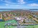 Aerial view showing waterfront property with marina, clubhouse, and tennis courts at 531 N Spoonbill Dr, Sarasota, FL 34236