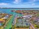 Aerial view of waterfront community with marina, tennis courts, and lush landscaping at 531 N Spoonbill Dr, Sarasota, FL 34236