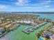 Aerial view of waterfront community with marina, clubhouse, and tennis courts at 531 N Spoonbill Dr, Sarasota, FL 34236