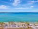 Aerial view of shoreline with palm trees, parking area and calm ocean water at 531 N Spoonbill Dr, Sarasota, FL 34236