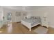 Main bedroom with light wood floors, white furniture and access to backyard at 531 N Spoonbill Dr, Sarasota, FL 34236