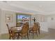 Bright dining room with hardwood table and chairs, offering a view of the outdoors at 531 N Spoonbill Dr, Sarasota, FL 34236