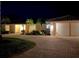 Attractive home exterior at night, featuring a three-car garage and landscaped grounds at 531 N Spoonbill Dr, Sarasota, FL 34236