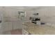 Spacious kitchen with granite island and white cabinetry at 531 N Spoonbill Dr, Sarasota, FL 34236