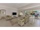 Bright living room with tiled floors, comfy seating, and sliding doors leading to the pool at 531 N Spoonbill Dr, Sarasota, FL 34236