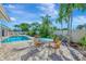 Peaceful poolside patio with seating area and lush landscaping at 531 N Spoonbill Dr, Sarasota, FL 34236