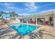 Inviting pool area with patio furniture and a spacious deck at 531 N Spoonbill Dr, Sarasota, FL 34236