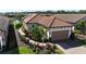 Single-story house with a tile roof and a landscaped yard at 5337 Popoli Way, Sarasota, FL 34238