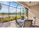 Screened patio overlooking a lake, with seating for four at 5337 Popoli Way, Sarasota, FL 34238