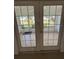 French doors leading to a patio with a view at 5345 Pamela Wood Way, Sarasota, FL 34233