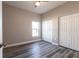 Simple bedroom with wood-look floors and double doors at 5534 Fairlane Dr, North Port, FL 34288