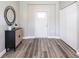 Bright entryway with gray vinyl flooring and closet at 5534 Fairlane Dr, North Port, FL 34288