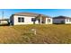 Rear view of a single-story house with a covered patio at 5534 Fairlane Dr, North Port, FL 34288