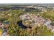 Aerial view of houses and a pond in a residential area at 5574 Sweetwater Oak, Sarasota, FL 34232