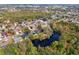 Aerial view showing a house nestled in a community near a pond at 5574 Sweetwater Oak, Sarasota, FL 34232