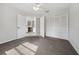 Bedroom with carpet flooring and access to kitchen and closet at 5574 Sweetwater Oak, Sarasota, FL 34232