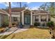 House with teal front door and white pergola at 5574 Sweetwater Oak, Sarasota, FL 34232