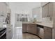 Modern kitchen with curved island and wood cabinets at 5574 Sweetwater Oak, Sarasota, FL 34232