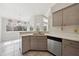 Modern kitchen with curved island and wood cabinets at 5574 Sweetwater Oak, Sarasota, FL 34232