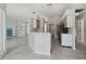 Kitchen with island, stainless steel appliances, and view into living area at 5574 Sweetwater Oak, Sarasota, FL 34232