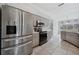 Modern kitchen featuring stainless steel appliances and light gray cabinets at 5574 Sweetwater Oak, Sarasota, FL 34232