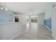 Kitchen with grey cabinets and view into spacious living room at 5574 Sweetwater Oak, Sarasota, FL 34232