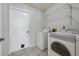 Laundry room with washer, dryer, and shelving unit at 5574 Sweetwater Oak, Sarasota, FL 34232