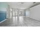 Living room with tile floors, French doors, and accent wall at 5574 Sweetwater Oak, Sarasota, FL 34232